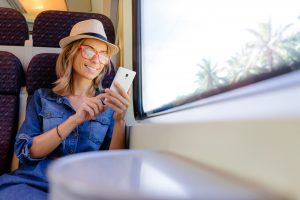 Traveler in Train Relaxing Using Phone